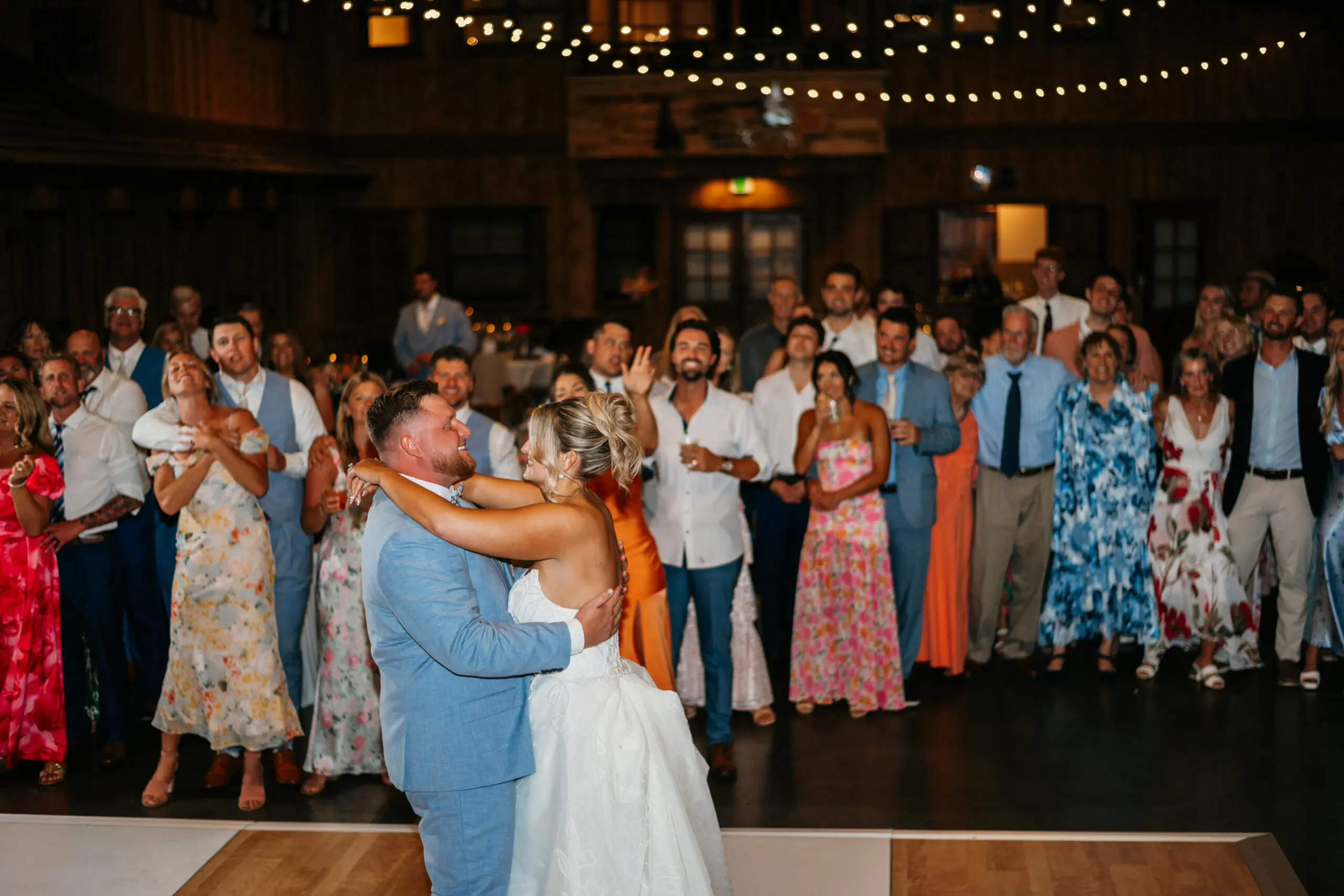 Wedding couple dancing surrounded by their guests